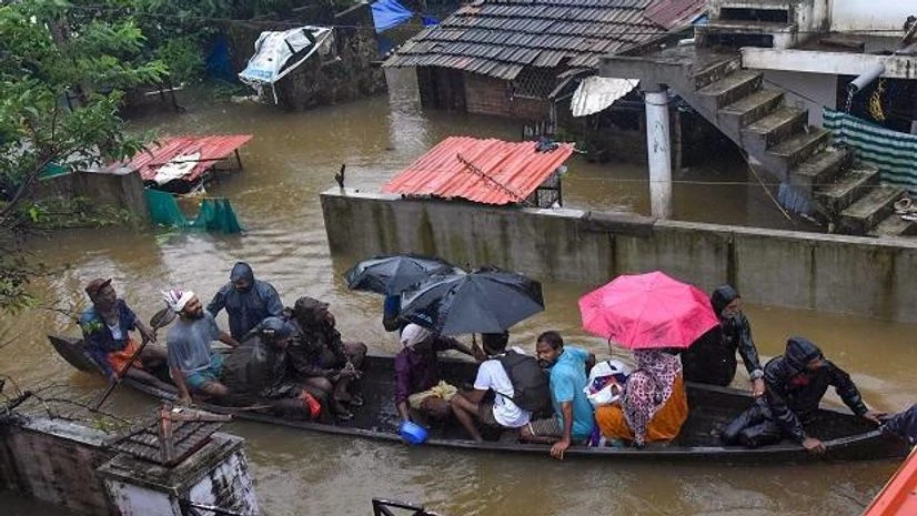 Kochi: Rescue officials assist villagers out of a flooded area, following heavy monsoon rainfall, near Kochi on Wednesday (Photo: PTI) Kochi: Rescue officials assist villagers out of a flooded area, following heavy monsoon rainfall, near Kochi on Wednesday (Photo: PTI)