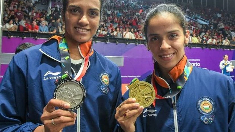 Asian Games 2018, P V Sindhu, Saina Nehwal P V Sindhu and Saina Nehwal pose with their medals at the Asian Games 2018. Photo: PTI