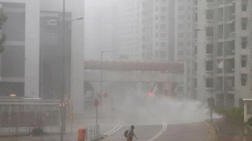 Typhoon Mangkhut A man walks as high waves hit the shore at Heng Fa Chuen, a residental district near the waterfront, as Typhoon Mangkhut slams Hong Kong, China