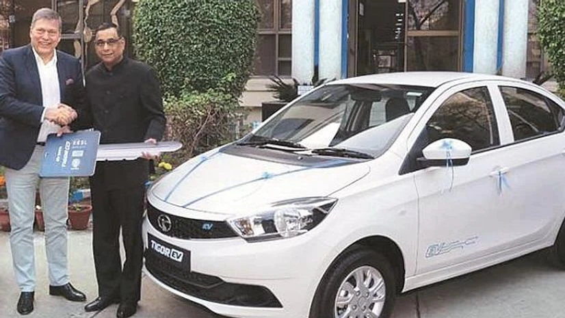Tat Motors MD and CEO Guenter Butschek Tata Motors MD and CEO Guenter Butschek (left) delivering the first batch of Tigor EV to EESL MD Saurabh Kumar in December 2017