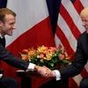 France's President Emmanuel Macron shakes hands with US President Donald Trump