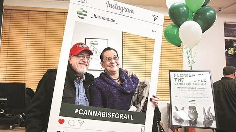 Instagram A couple poses behind a cardboard Instagram frame