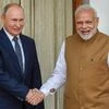 Prime Minister Narendra Modi shakes hands with Russian President Vladimir Putin before their meeting at Hyderabad House, in New Delhi, Friday
