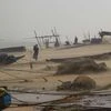 Fishermen engaged in their work as Cyclone Titli hits the coast in Ganjam