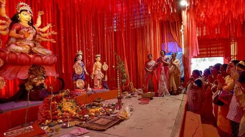 durga puja, pandal People offer prayers on the occasion of Maha Saptami at a puja pandal during Durga Puja festival, in Kolkata, Tuesday
