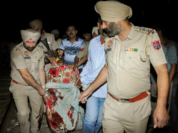 At least 59 killed as train hits crowd in northern India At least 59 killed as train hits crowd in northern India