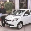 Tata Motors MD & CEO Guenter Butschek (left) hands over a symbolic key of Tigor EV to EESL MD Saurabh Kumar in 2017