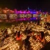 People light earthen lamps on the banks of River Saryu during Deepotsav