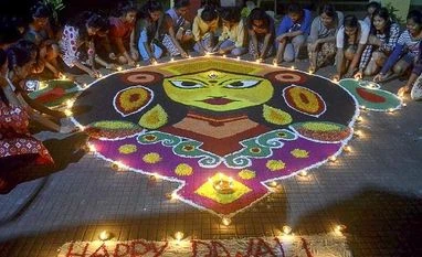 Samvat 2076: Top stocks that leading brokerages are bullish on Students create a rongoli to celebrate Diwali festival in Guwahati