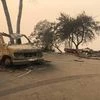 The wreckage of a vehicle is seen along the road in the aftermath of wildfires in Paradise, California