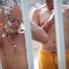 Migrants, part of a caravan of thousands from Central America trying to reach the United States, shower as they rest in a shelter in Tijuana, Mexico