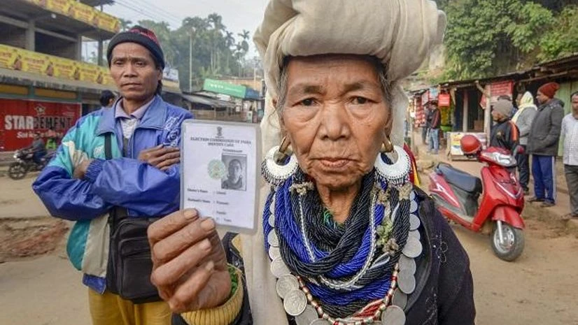 A Bru tribal woman shows her identity card in Kanhmun, Mizoram. Photo: PTI A Bru tribal woman shows her identity card as she waits to cast her vote at a polling station for the state Assembly elections, at Kanhmun, Mizoram. Photo: PTI
