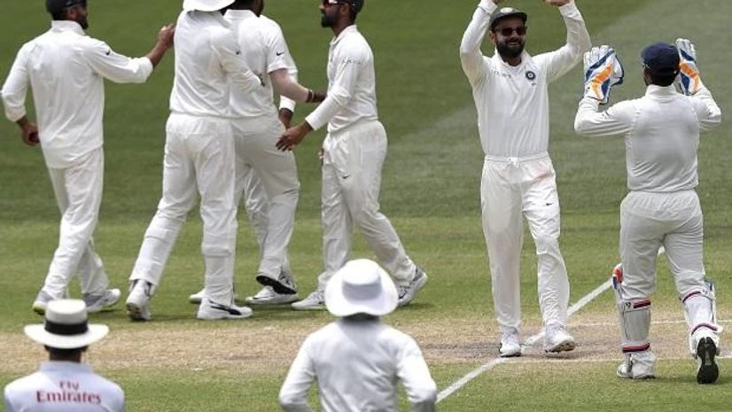 India, australia, cricket, Indian players celebrate the dismissal of Australia's Tim Paine on the final day of the first cricket test between Australia and India in Adelaide. AP/PTI
