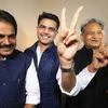 Congress leaders Ashok Gehlot (R) and Sachin Pilot (C) flash victory signs as K C Venugopal looks on after the declaration of Rajasthan Assembly election result, in Jaipur