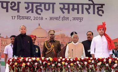 Rajasthan govt to get new ministers, 23 MLAs to take oath Monday Rajasthan Chief Minister Ashok Gehlot, Deputy Chief Minister Sachin Pilot and Governor Kalyan Singh stand for the national anthem after the swearing-in ceremony, at Albert Hall in Jaipur, Monday, Photo: PTI