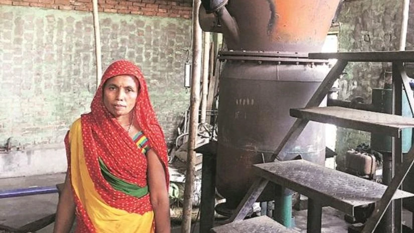 biomass plant Bhalo Devi, who runs a biomass plant, switches on the power supply from solar panels and operates machines and gasifiers at Mahalgaon in Araria district, Bihar