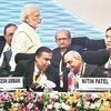 Prime Minister Narendra Modi walks past Reliance Industries Chairman Mukesh Ambani and Gujarat Deputy Chief Minister Nitin Patel at the Vibrant Gujarat Global Summit 2019 in Gandhinagar on Friday. Photo: PTI
