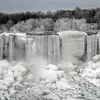 Water flows around ice, formed on the American Falls in Niagara Falls, New York, due to subzero temperatures