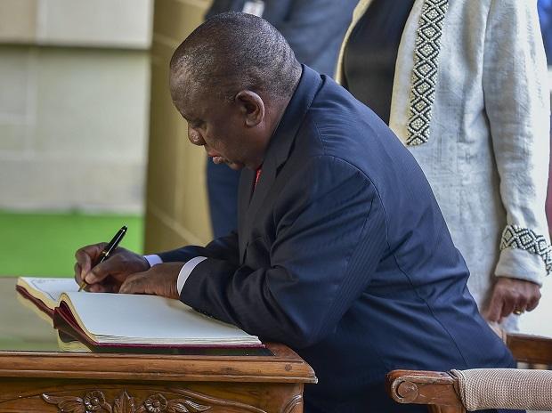 Cyril Ramaphosa writes his message on the visitors book during their visit to Mahatma Gandhi's memorial Rajghat Cyril Ramaphosa writes his message on the visitors book during their visit to Mahatma Gandhi's memorial Rajghat