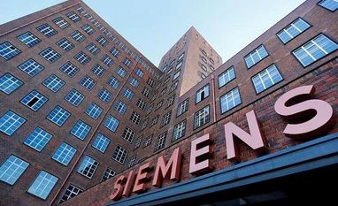 Siemens reports stronger than expected results, to review outlook The Siemens logo is seen on a building in Siemensstadt in Berlin, Germany