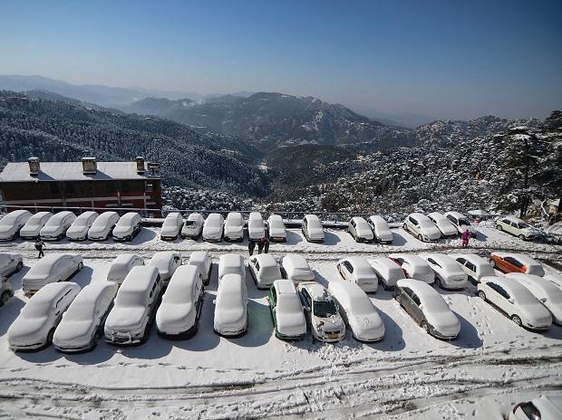 Vehicles covered under snow at a parking area following heavy snowfall, in Shimla Vehicles covered under snow at a parking area following heavy snowfall, in Shimla