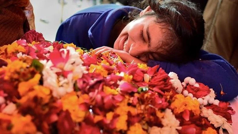 Pulwama attack A family member of slain CRPF Mahesh Yadav cries before his funeral at Tudihar, in Allahabad district, Saturday (Photo: PTI)