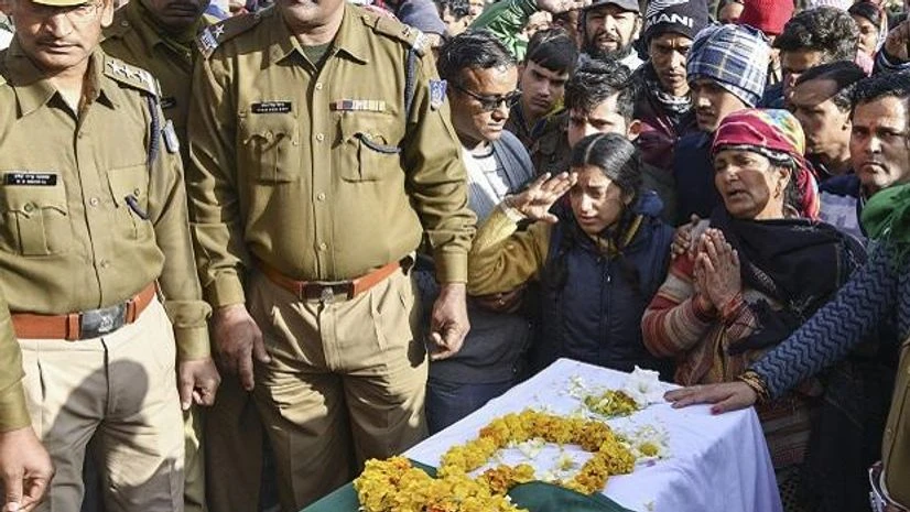 Daughter and wife of slain CRPF Jawan Mohan Lal pay their last respects after a wreath-laying ceremony, in Dehradun, Saturday, Feb. 16, 2019. Lal lost his life in Pulwama terror attack. Photo: PTI Pulwama terror attack