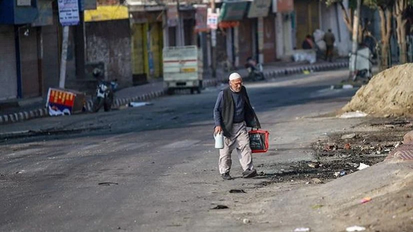Jammu: An elderly man walks along a street during a curfew imposed after clashes between two communities over the protest against the Pulwama terror attack, in Jammu, Saturday. PTI Photo Jammu: An elderly man walks along a street during a curfew imposed after clashes between two communities over the protest against the Pulwama terror attack, in Jammu, Saturday. PTI Photo