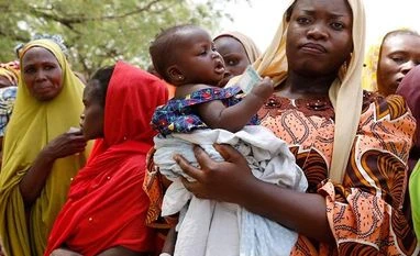 Nigeria elections Woman carries her child as she attends to cast her vote during Nigeria's presidential election at Capital School polling unit, in Yola (Photo: Reuters)