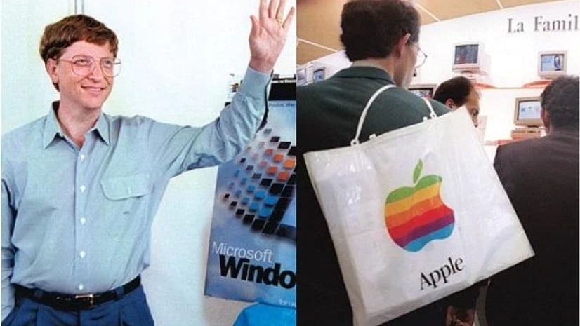 Then Microsoft CEO Bill Gates (left) stands beside a model of the new Windows 95 product days before its launch. People at the Apple Expo (right) in CNIT centre, Paris, on September 15, 1995. Microsoft and Apple were major players in the personal-co Then Microsoft CEO Bill Gates (left) stands beside a model of the new Windows 95 product days before its launch. People at the Apple Expo (right) in CNIT centre, Paris, on September 15, 1995. Microsoft and Apple were major players in the personal-co