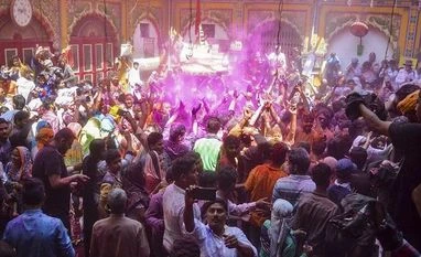Mathura court moved for removal of mosque within Krishna temple premises A priest of Dwarkadheesh temple tosses Gulal towards devotees during week-long Holi celebrations, in Mathura