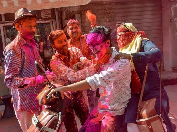People smear 'Gulal' at each other during Holi celebrations in Lucknow People smear 'Gulal' at each other during Holi celebrations in Lucknow
