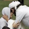Muslim men embrace during Friday prayers at Hagley Park in Christchurch | Photo: Reuters