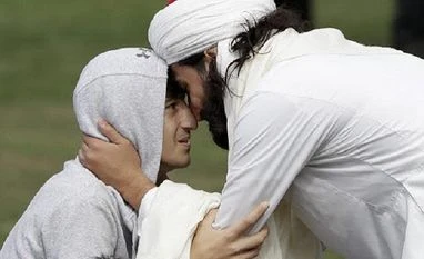 Tearful Muslims return to Christchurch mosque as NZ works to move on Muslim men embrace during Friday prayers at Hagley Park in Christchurch | Photo: Reuters