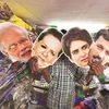 A salesman displays masks of Prime Minister Narendra Modi, Congress leaders Sonia Gandhi and Priyanka Gandhi Vadra, and AAP leader Arvind Kejriwal at a shop in New Delhi on the eve of the first phase of polling | Photo: PTI