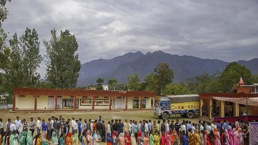 Voters stand in a queue to cast vote during the second phase of general elections, at polling station in Tikri of Udhampur district in Jammu and Kashmir, Thursday, April 18, 2019 | Photo: PTI Voters stand in a queue to cast vote during the second phase of general elections, at polling station in Tikri of Udhampur district in Jammu and Kashmir, Thursday, April 18, 2019 | Photo: PTI
