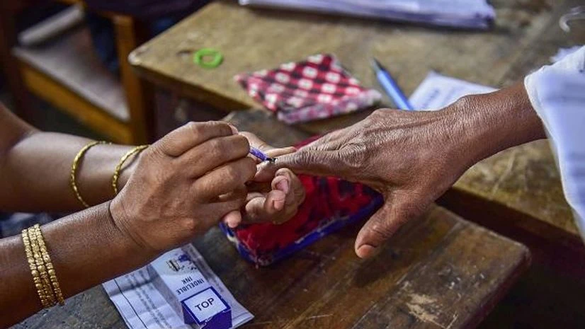 A polling officer puts an indelible ink mark on the finger of a voter during the second phase of the general elections, at a polling station, in Nagaon, Thursday, April 18, 2019 | Photo: PTI A polling officer puts an indelible ink mark on the finger of a voter during the second phase of the general elections, at a polling station, in Nagaon, Thursday, April 18, 2019 | Photo: PTI