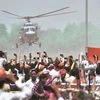 BJP supporters wave towards the helicopter of Prime Minister Narendra Modi as he leaves after an election campaign rally, in Muzaffarpur : Photo: PTI