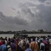 Cyclone Fani: Office goers wait for a ferry to travel across a river during rainfall, in Kolkata, Friday, May 3, 2019. (PTI Photo)