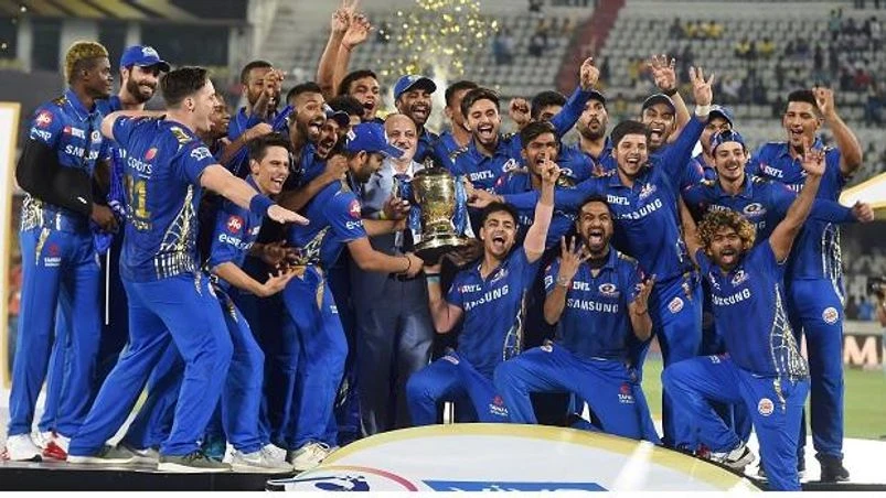 IPL 2019, Mumbai Indians, Mumbai Indians (MI) skipper Rohit Sharma with his teammates celebrating with Indian Premier League 2019 winning trophy after win over Chennai Super Kings (CSK) at the Final cricket match at Rajiv Gandhi International Cricket Stadium in Hyderabad. Pho