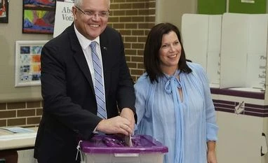 Australia launches anti-espionage task force after China spy claims Australian Prime Minister Scott Morrison (left) is assisted by his wife, Jenny, as he casts his ballot in a federal election in Sydney Photo: AP/PTI