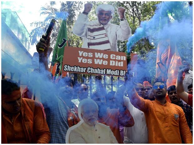 BJP supporters celebrate outside the party headquarters in New Delhi BJP supporters celebrate outside the party headquarters in New Delhi