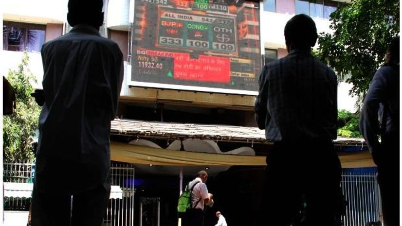 People watches stock market screen display on the facade of the Bombay Stock Exchange People watches stock market screen display on the facade of the Bombay Stock Exchange