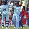 England's captain Eoin Morgan, right, celebrates with teammate Joe Root after scoring a century