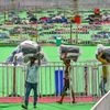Ranchi: Workers carry yoga mats in preparation at the venue of 5th International Yoga Day, in Ranchi, Thursday, June 20, 2019. Prime Minister Narendra Modi will be joining the programme in the city on Friday.| PTI Photo