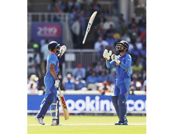 India's captain Virat Kohli, left, passes the bat back to teammate K.L. Rahul after the latter dropped it while taking a run India's captain Virat Kohli, left, passes the bat back to teammate K.L. Rahul after the latter dropped it while taking a run