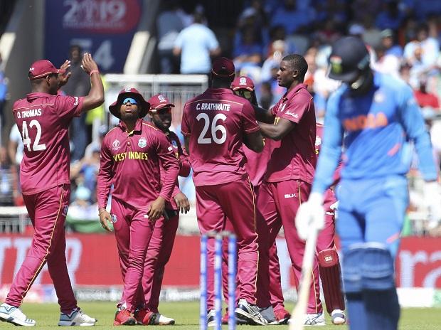 West Indies' captain Jason Holder, second right, celebrates with teammates the dismissal of India's K.L. Rahul, right West Indies' captain Jason Holder, second right, celebrates with teammates the dismissal of India's K.L. Rahul, right