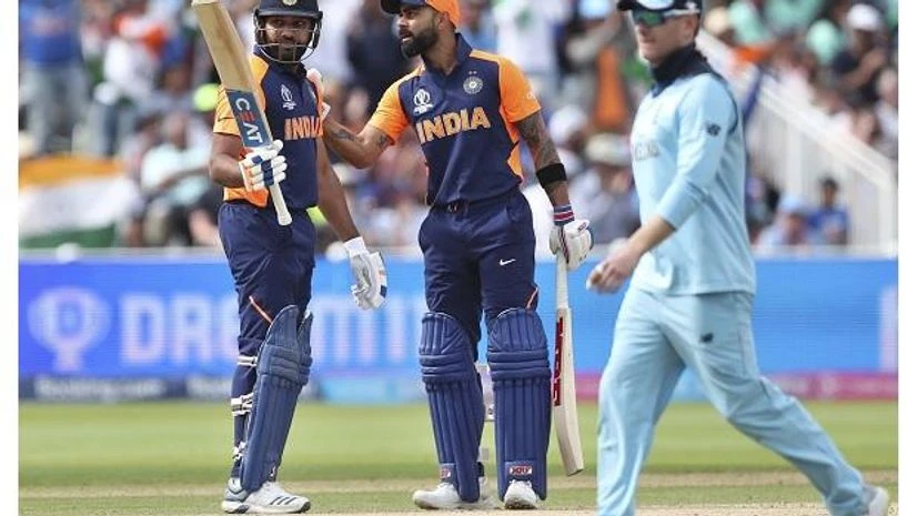 Birmingham: India's Rohit Sharma, left, raises his bat to celebrate scoring fifty runs during the Cricket World Cup match between England and India at Edgbaston in Birmingham, England, Sunday, June 30, 2019. AP/PTI Photo Birmingham: India's Rohit Sharma, left, raises his bat to celebrate scoring fifty runs during the Cricket World Cup match between England and India at Edgbaston in Birmingham, England, Sunday, June 30, 2019. AP/PTI Photo