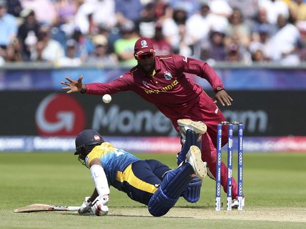 Sri Lanka's batsman Avishka Fernando, left, dives to survive a run out as West Indies' Fabian Allen attempt to catch the ball Sri Lanka's batsman Avishka Fernando, left, dives to survive a run out as West Indies' Fabian Allen attempt to catch the ball