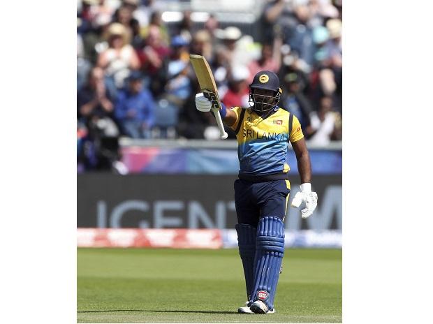 Sri Lanka's batsman Kusal Perera raises his bat after scoring a half century Sri Lanka's batsman Kusal Perera raises his bat after scoring a half century